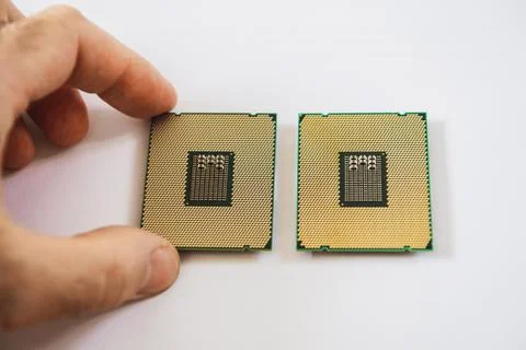 Two new powerful workstation CPU processors man hand 스톡 사진