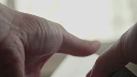 Two new video tapes in man hands. Old fashioned technologies. Stock Footage 153554591