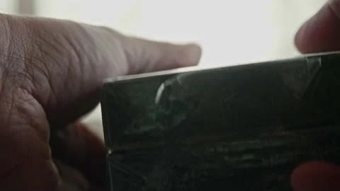 Two new video tapes in man hands. Old fashioned technologies. Stock Footage 153555110