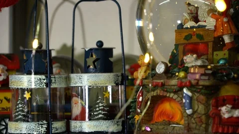 Two New Year's lights and a snow globe illuminated by holiday lights Stock Footage 119958903