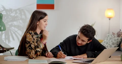 Two nice Hispanic teen students finding homework solution studying together at Video stock 120946371