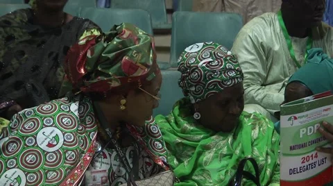 Two Nigerian Women Look at Program PDP Convention 2014 Stock Footage 58022326