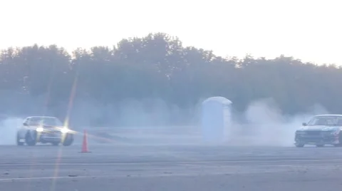 Two Nissan's rip around corner side by side in drift racing event. Stock-Footage 59762260