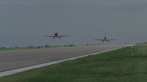 Two North American T-6 Texan warbirds taking off from Wittman Regional Airport Stock Footage 50186657