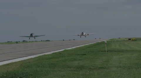Two North American T-6 Texan warbirds taking off from Wittman Regional Airport Stock Footage 50186843