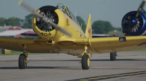 Two North American T-6 Texan warbirds on runway of Wittman Regional Airport Stock Footage 50186905