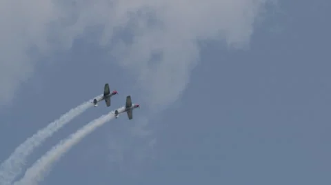 Two North American T-6 Texan warbirds performing at EAA AirVenture Oshkosh Stock Footage 50189037