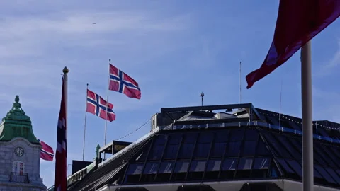 Two Norwegian flags move in the wind on a rooftop in Oslo 2 Stock Footage 275206440