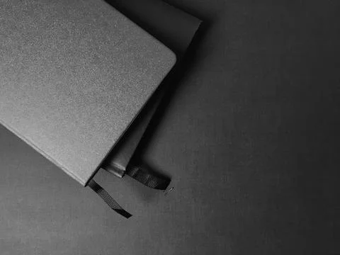Two notebooks with bookmarks on a dark background Stock Photos