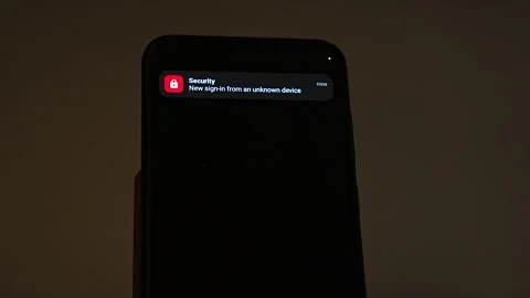 Two notifications arrive on a smartphone in a dark room: a parcel on hold Stock Footage 347516739