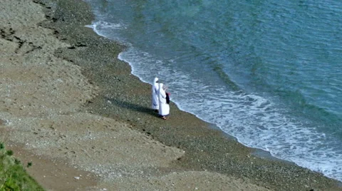 Two nuns on the beach Stock Footage 57356082