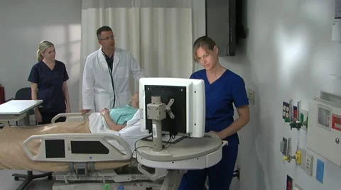 Two nurses and doc attend female patient Stock Footage 11140277