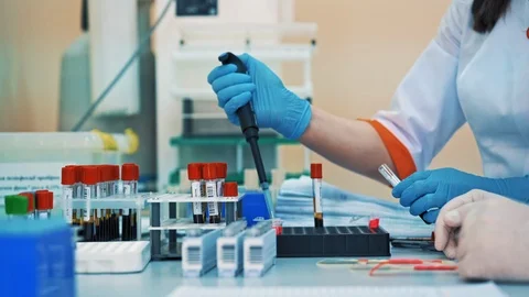 Two nurses are working with test tubes in medical laboratory. Scientists women Stock Footage 108582677