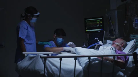 Two Nurses Helping the Elderly Patient in the Bed Stock Footage 264093917