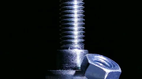 Two Nuts and bolt  rotates  against  dark background. 4K   macro 库存影片 61459447