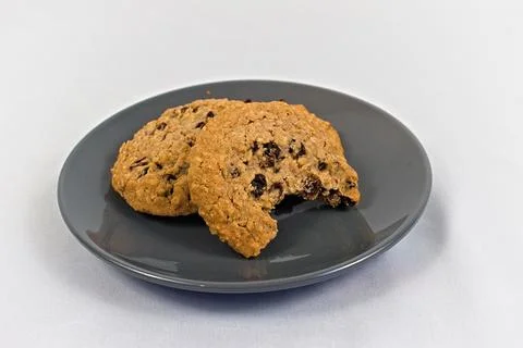 Two Oatmeal Cookies Missing a Bite on Gray Plate Stock Photos