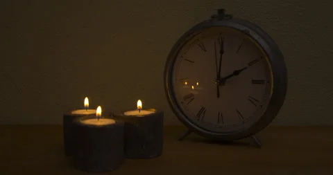Two o'clock at night, dark scene of wooden table with homey objects, clock Stock Footage 136208191