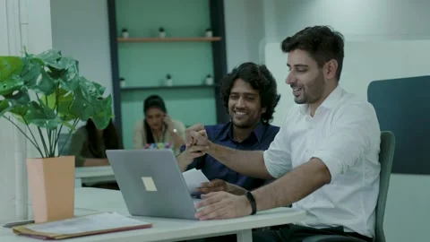 Two office Asian workers talking in office,young Indian colleagues discussing. Stock Footage 163403299