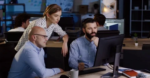 Two office co-workers discussing with a senior worker their business project Stock Footage 82447373