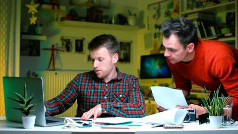 Two office workers discuss documents at the table. Stock Footage 120424888
