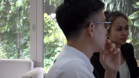 Two office workers discuss work in the office. Stock Footage 103034765