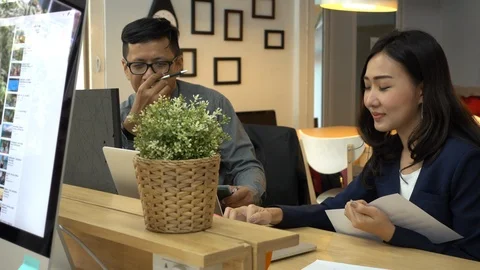 Two office workers discuss work in the office. Stock Footage 103035868