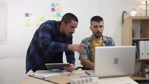 Two office workers discussing and planning. Colleagues creative design strategy Stock Footage 140516188