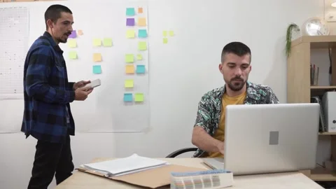 Two office workers discussing and planning. Colleagues creative design strategy Stock Footage 140516411