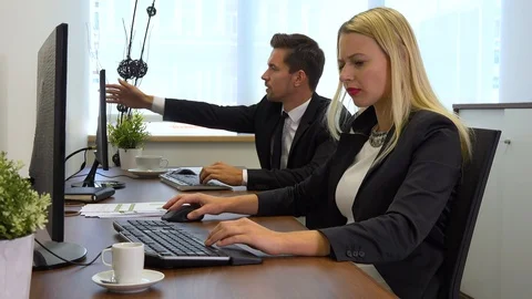 Two office workers, man and woman, have technical problems with their computers Stock Footage 103456083