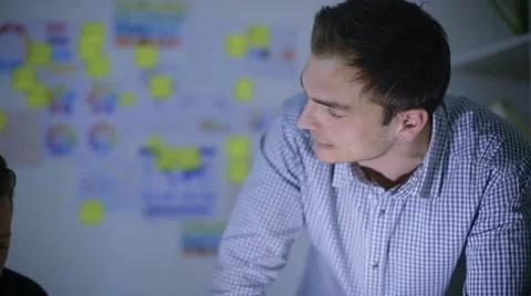 Two office workers remained late to complete some documents Stock Footage 62550153