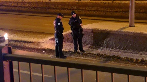 Two officers analyzing rollover scene Stock Footage 103868885