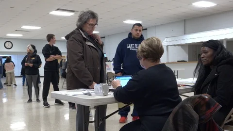 Two Ohio voters present ID to clerk Stock Footage 106037062