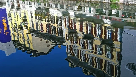 Two old and characteristic houses of Milan reflected on the water of the Navi Stock Footage 107331908