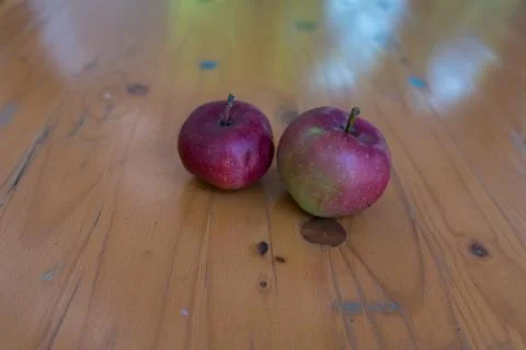 Two old apples on a table Stock Photos