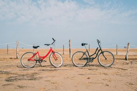 Two old bikes at the beach in front of the sea Stock Photos