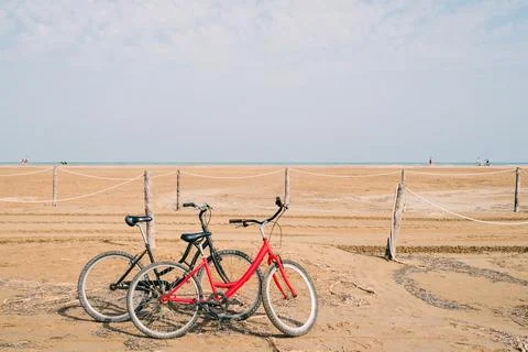 Two old bikes at the beach in front of the sea Stock Photos