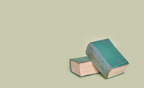 Two old books lie on a plain background. Banner Stock Photos