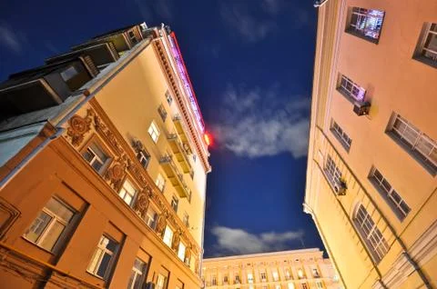 Two old buildings on a background cloudy nightly sky Stock Photos