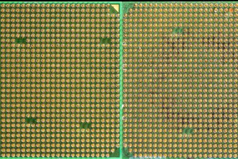 Two old computer processors with gilt legs, on a green board, top view Foto stock