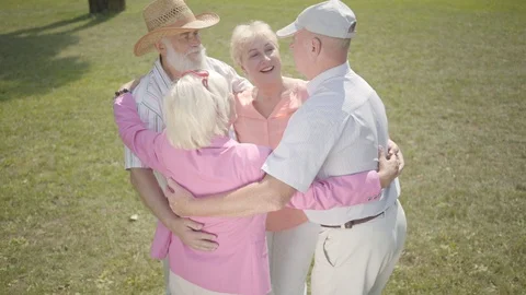 Two old couples hugging in the park stan... | Stock Video | Pond5