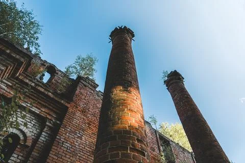 Two old, dilapidated, brick columns, bottom-up view Stock Photos