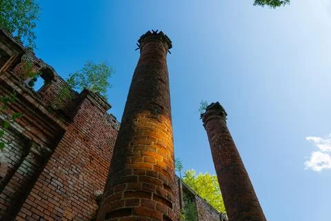 Two old, dilapidated, brick columns, bottom-up view Stock Photos
