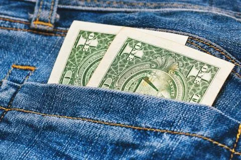 Two old dollar banknotes in jeans pocket Stock Photos