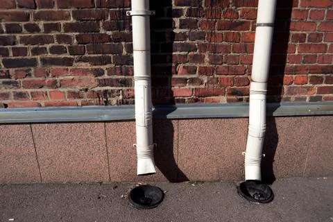 Two old drainpipes on a brick wall Foto stock