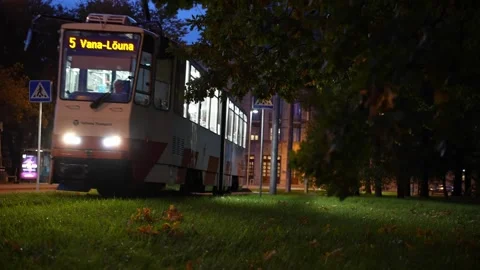 Two old empty trams come and go from tramstation in local park, long shot Stock Footage 310172239