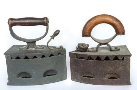 Two old flatirons on white background Stock Photos
