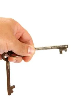 Two old keys in hand isolated on a white background. Stock Photos