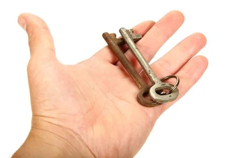 Two old keys in hand isolated on a white background. Stock Photos