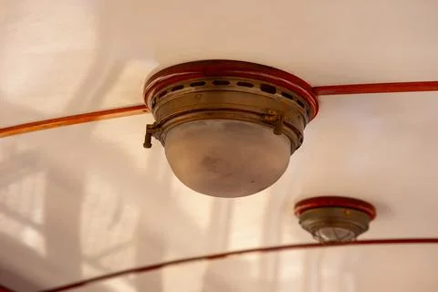 Two old lamps on the ceiling of a train car Stock Photos