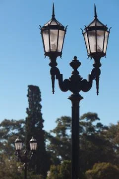 Two old lanterns against the blue sky Stock Photos
